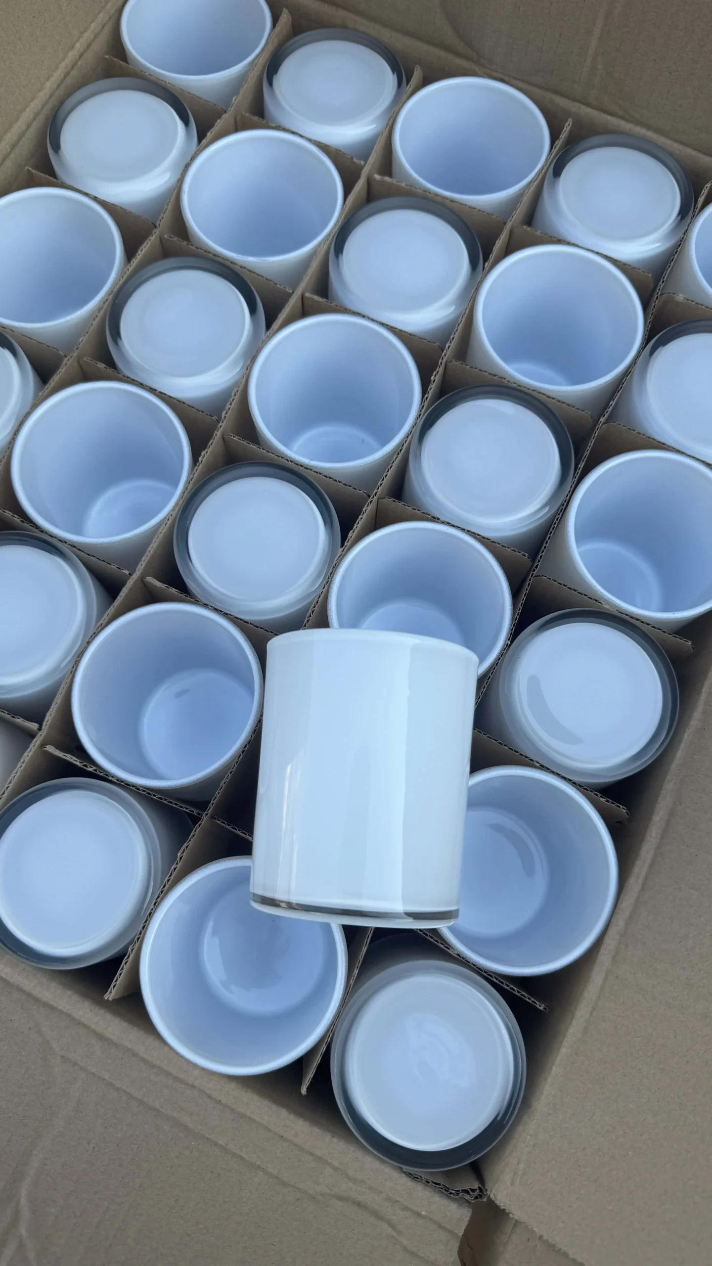 White glass candle jar produced on the factory line