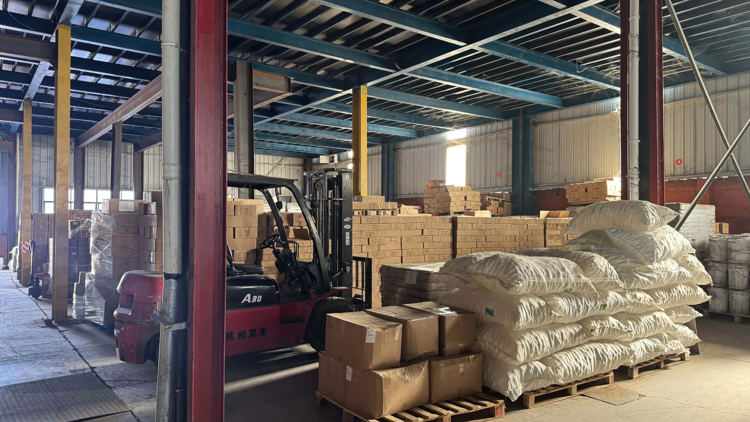 Bulk finished glass goods stacked in warehouse ready for wholesale export