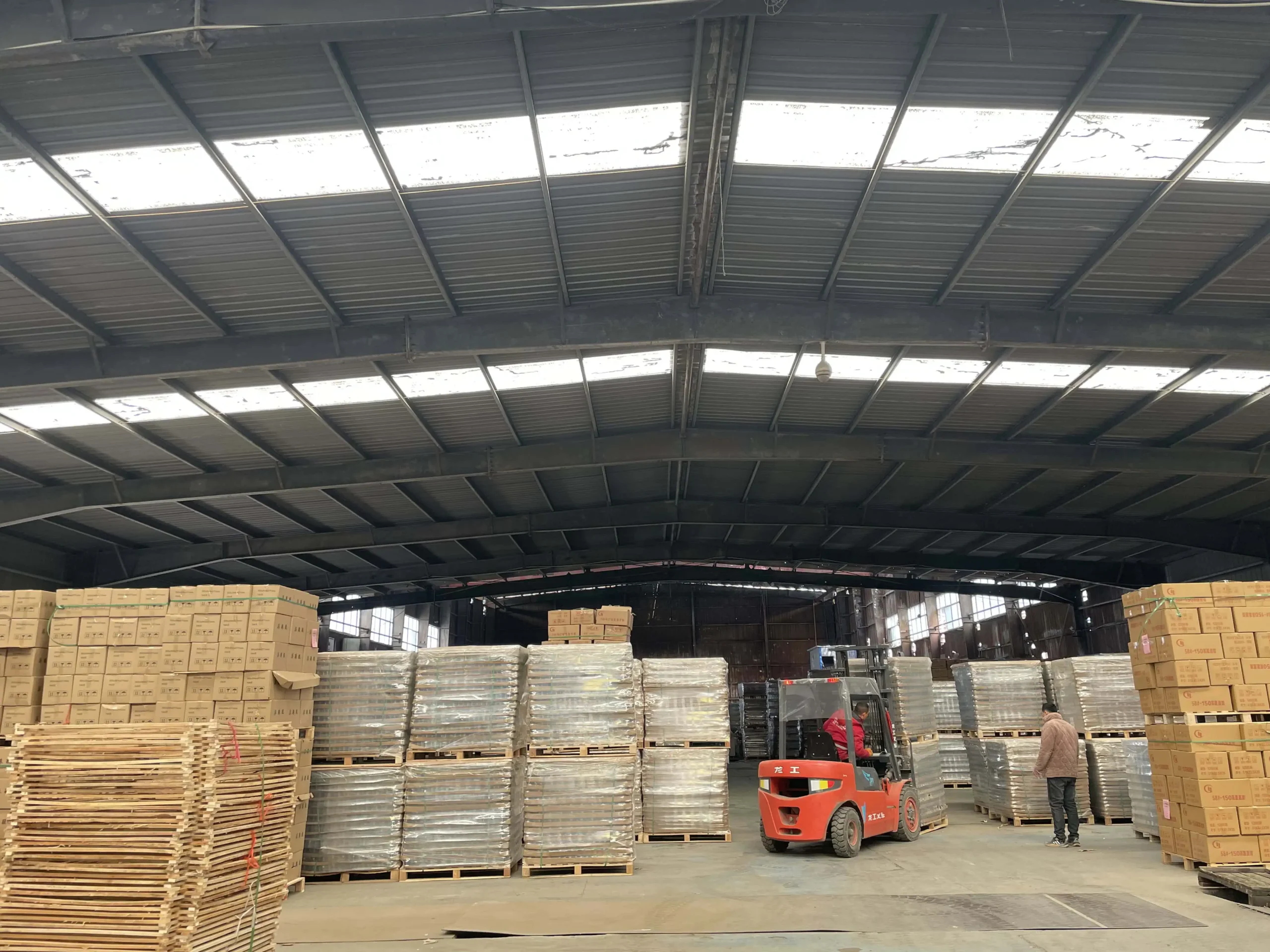 Luxury glass bottles being carefully packed in foam-lined export cartons