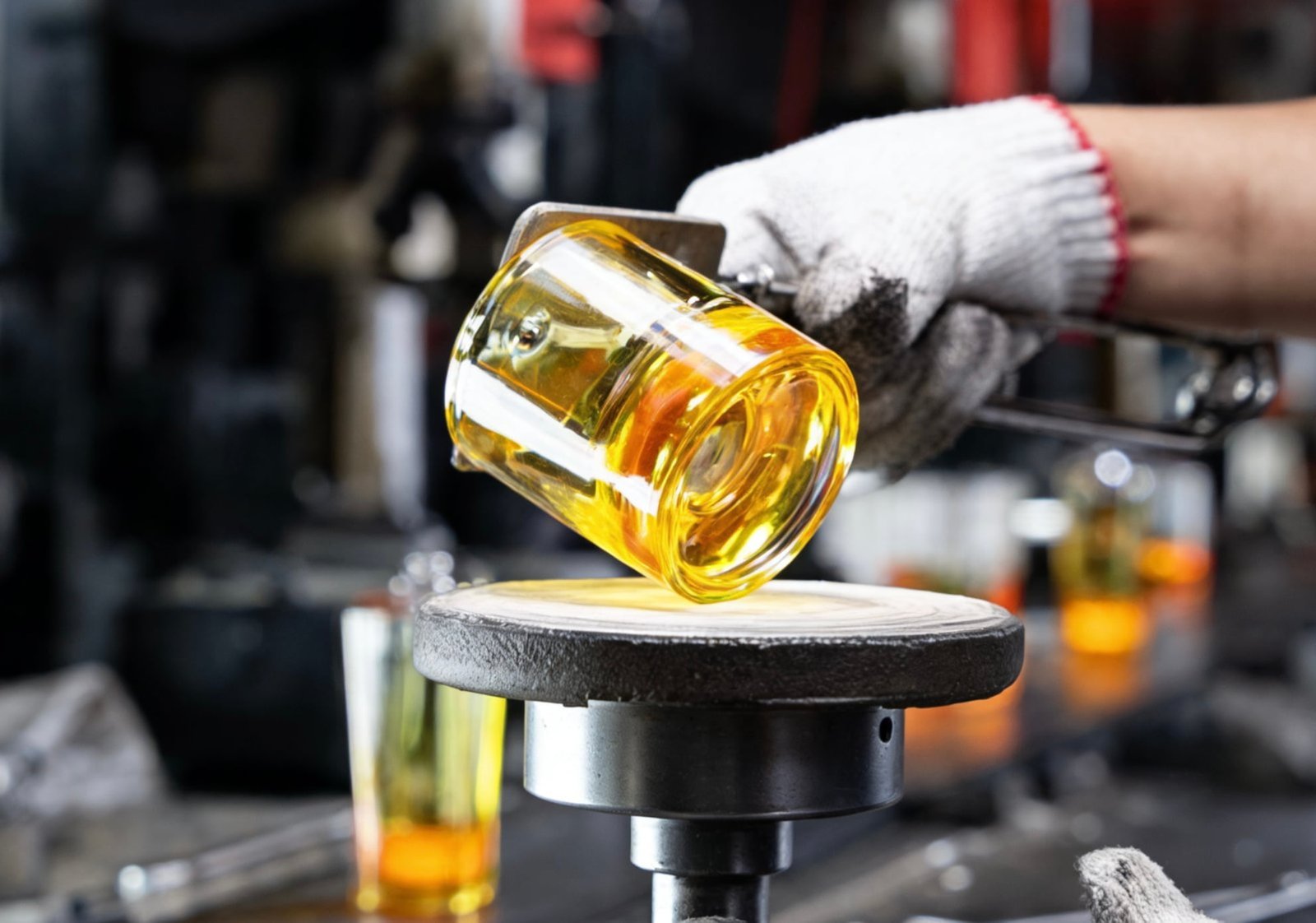 Trial production glass bottle samples being inspected for quality