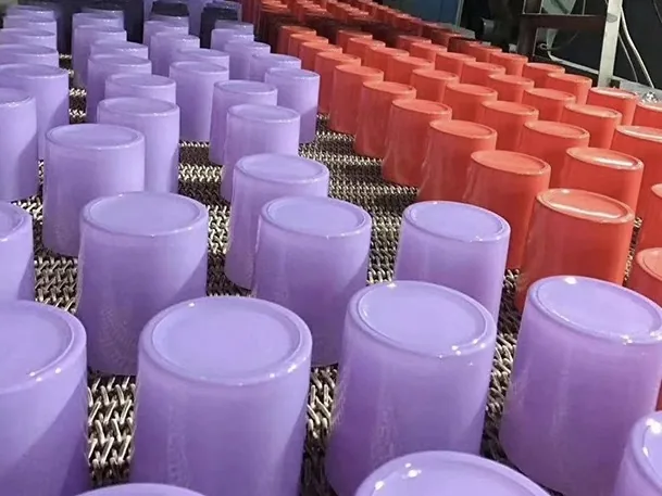 Color-coated glass candle jars on the automated production line